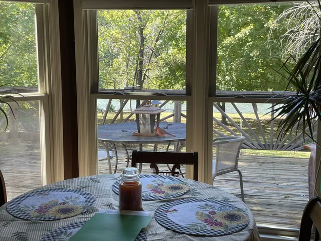 a living room with fireplace furniture and a floor to ceiling window