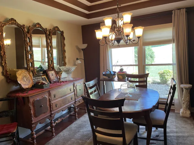 a view of a dining room with furniture and window