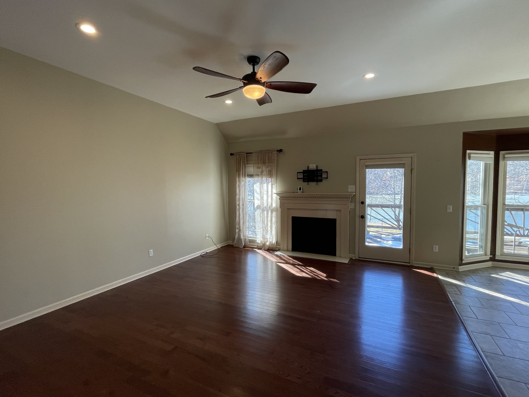 514 Lakeside Drive Springfield, TN 37172 - Photo 17 of 36 a view of an empty room with wooden floor a fireplace and a window