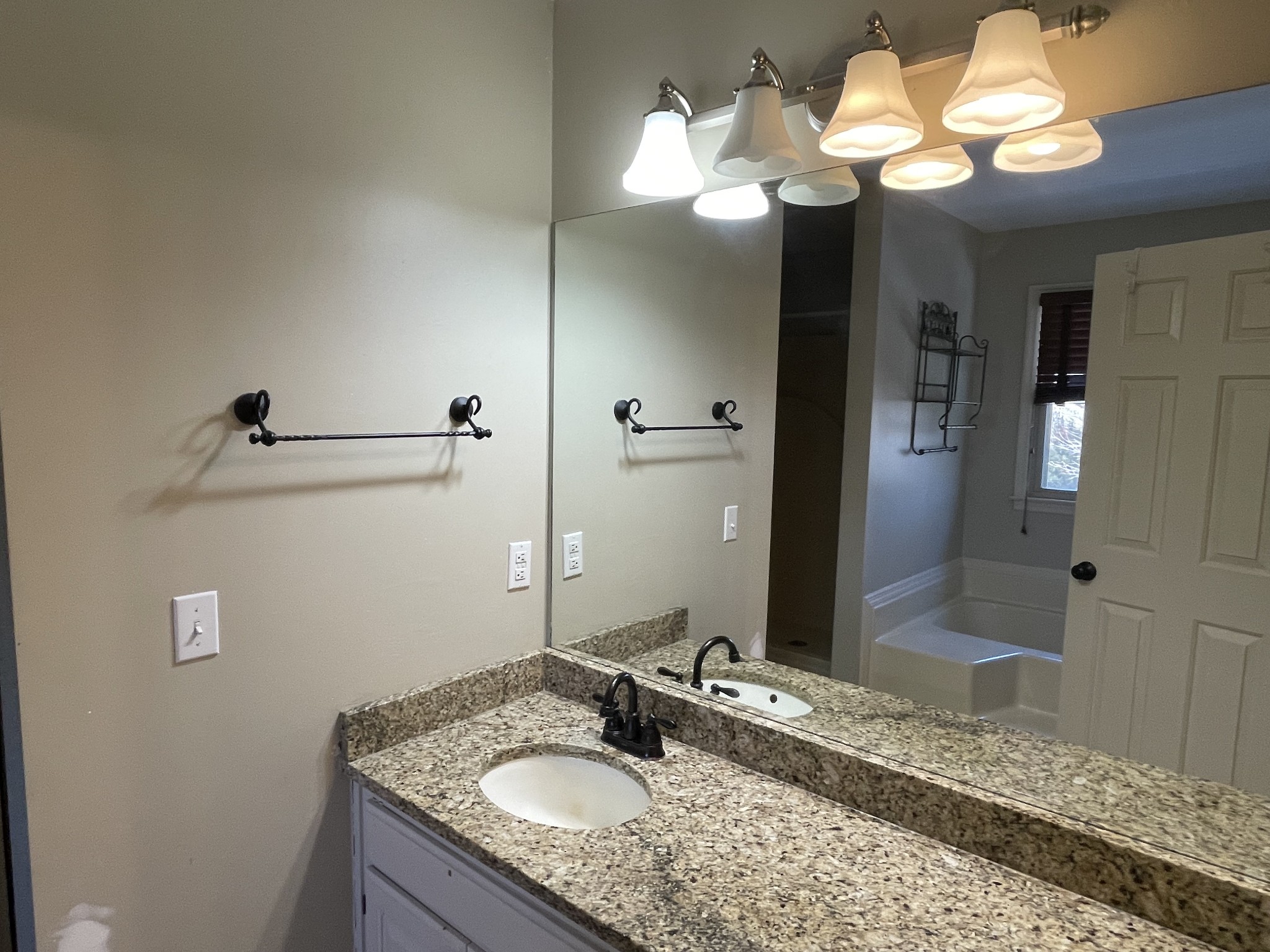 514 Lakeside Drive Springfield, TN 37172 - Photo 27 of 36 a bathroom with a granite countertop sink a light fixture and a mirror