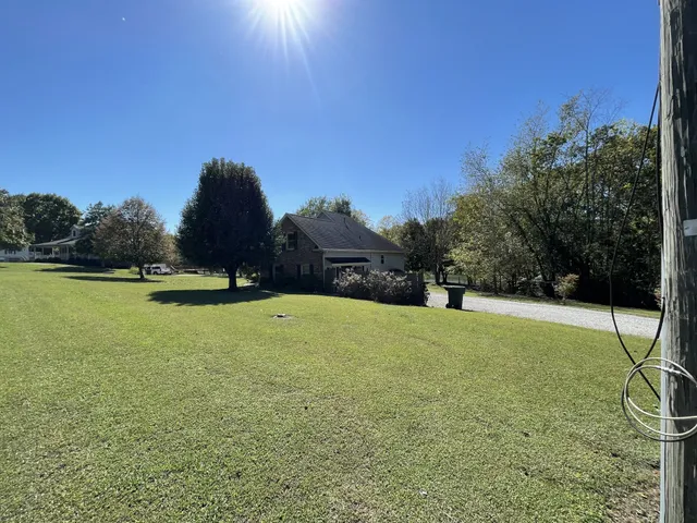 a view of a field of grass and trees