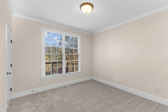 a view of a hallway to a bedroom with wooden floor