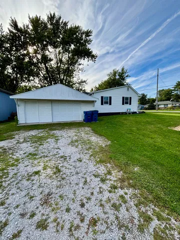 a front view of house with yard and trees