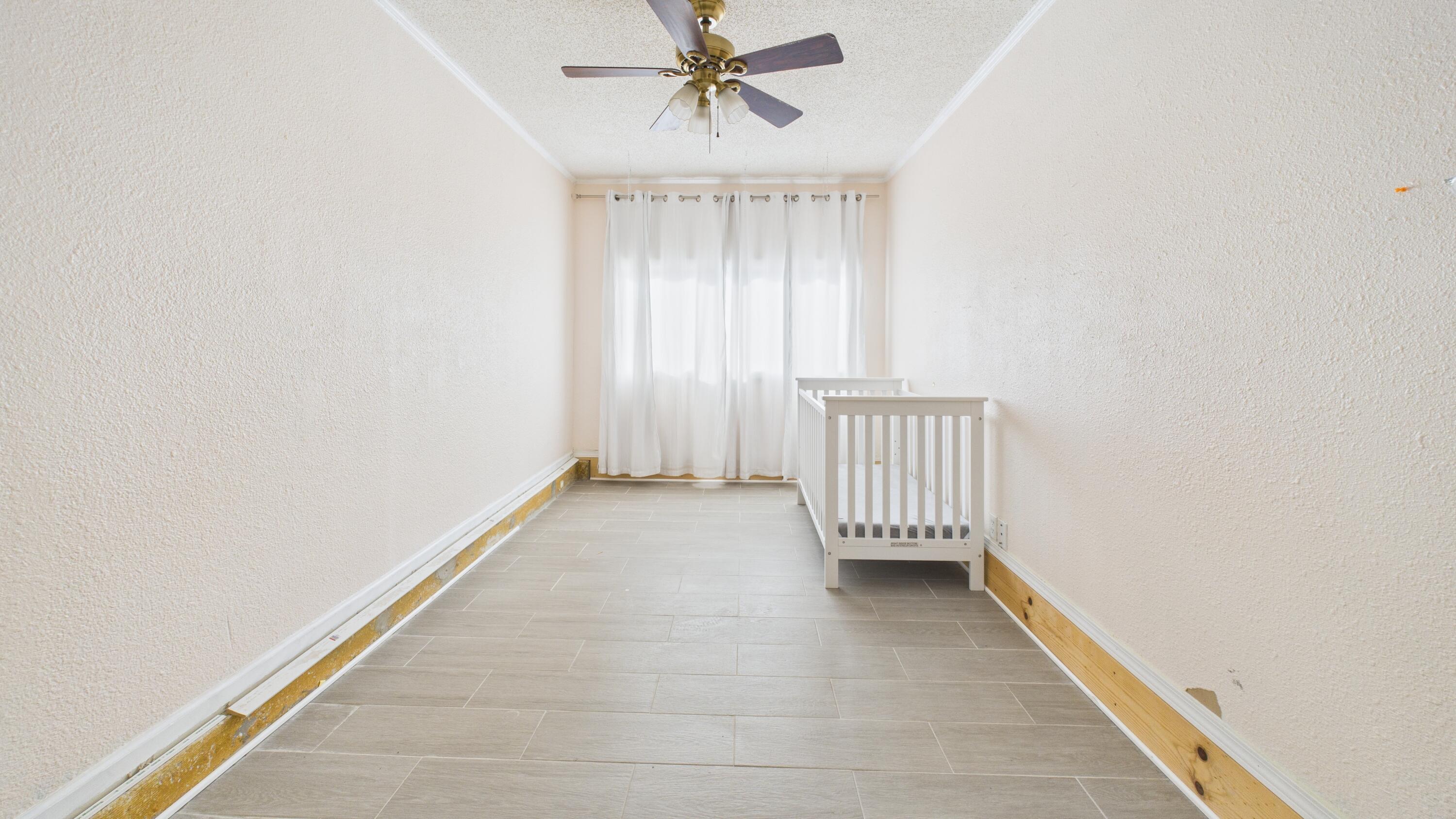 5410 41st Street Lubbock, TX 79414 - Photo 14 of 40 an empty room with a window and a chandelier fan