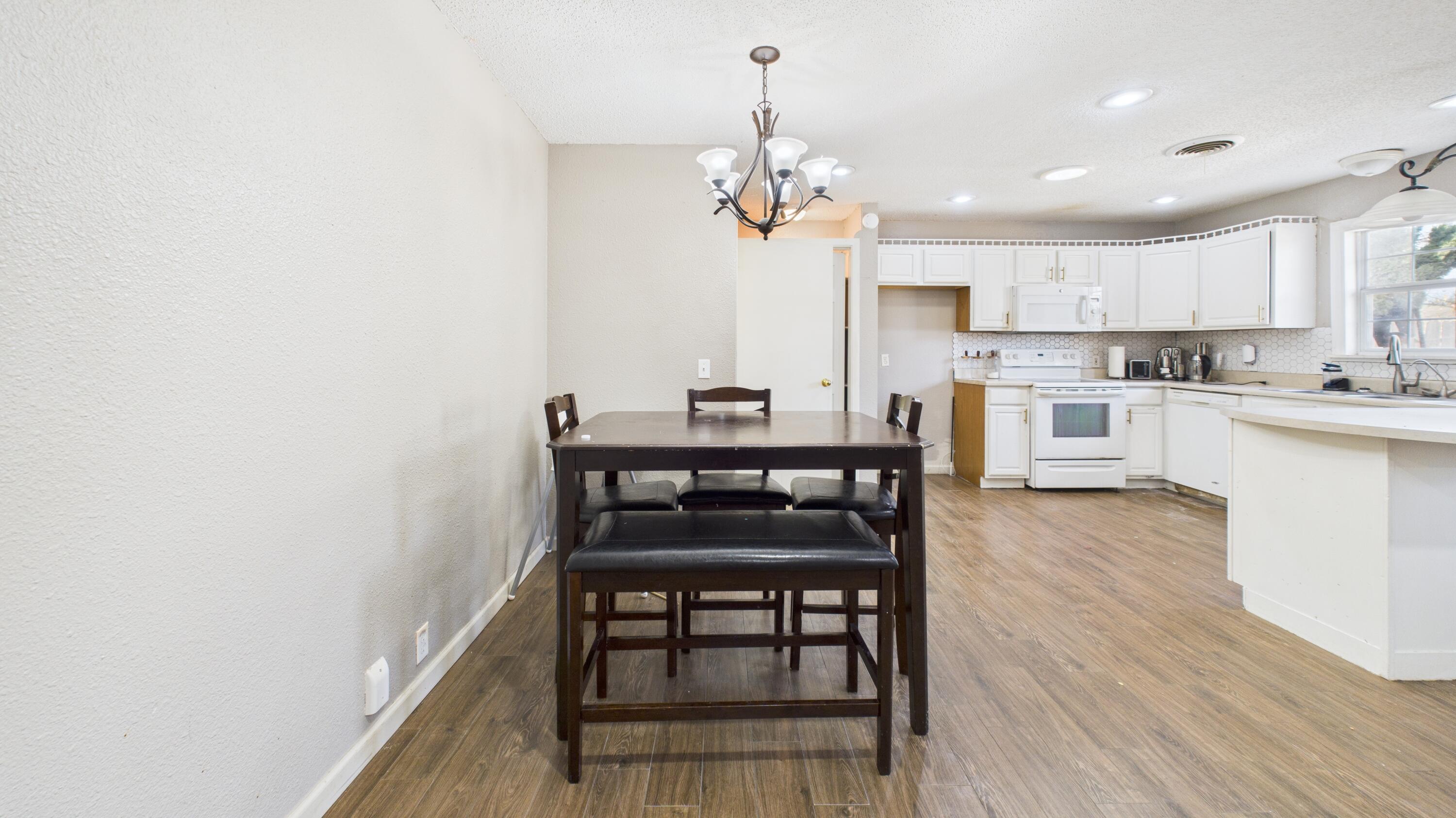 5410 41st Street Lubbock, TX 79414 - Photo 21 of 40 a view of a dining room with furniture and wooden floor