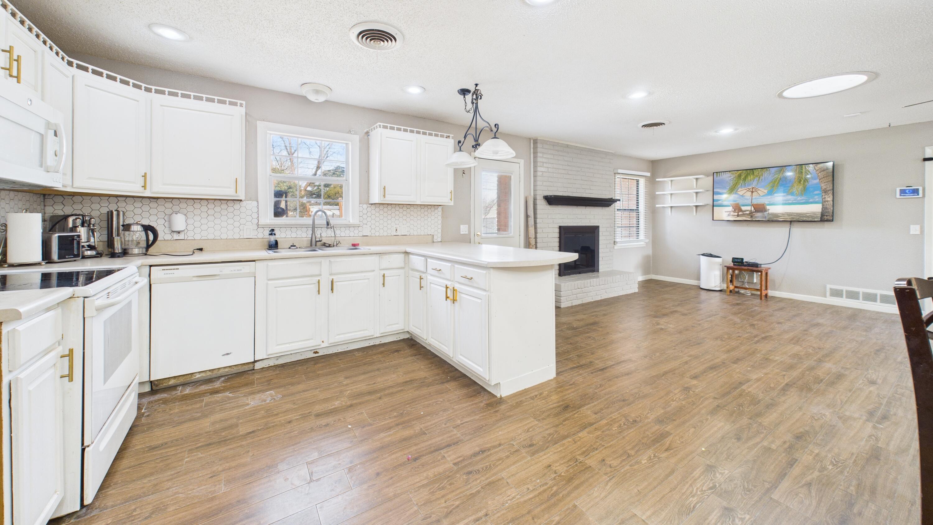 5410 41st Street Lubbock, TX 79414 - Photo 24 of 40 a kitchen with stainless steel appliances a sink stove and cabinets