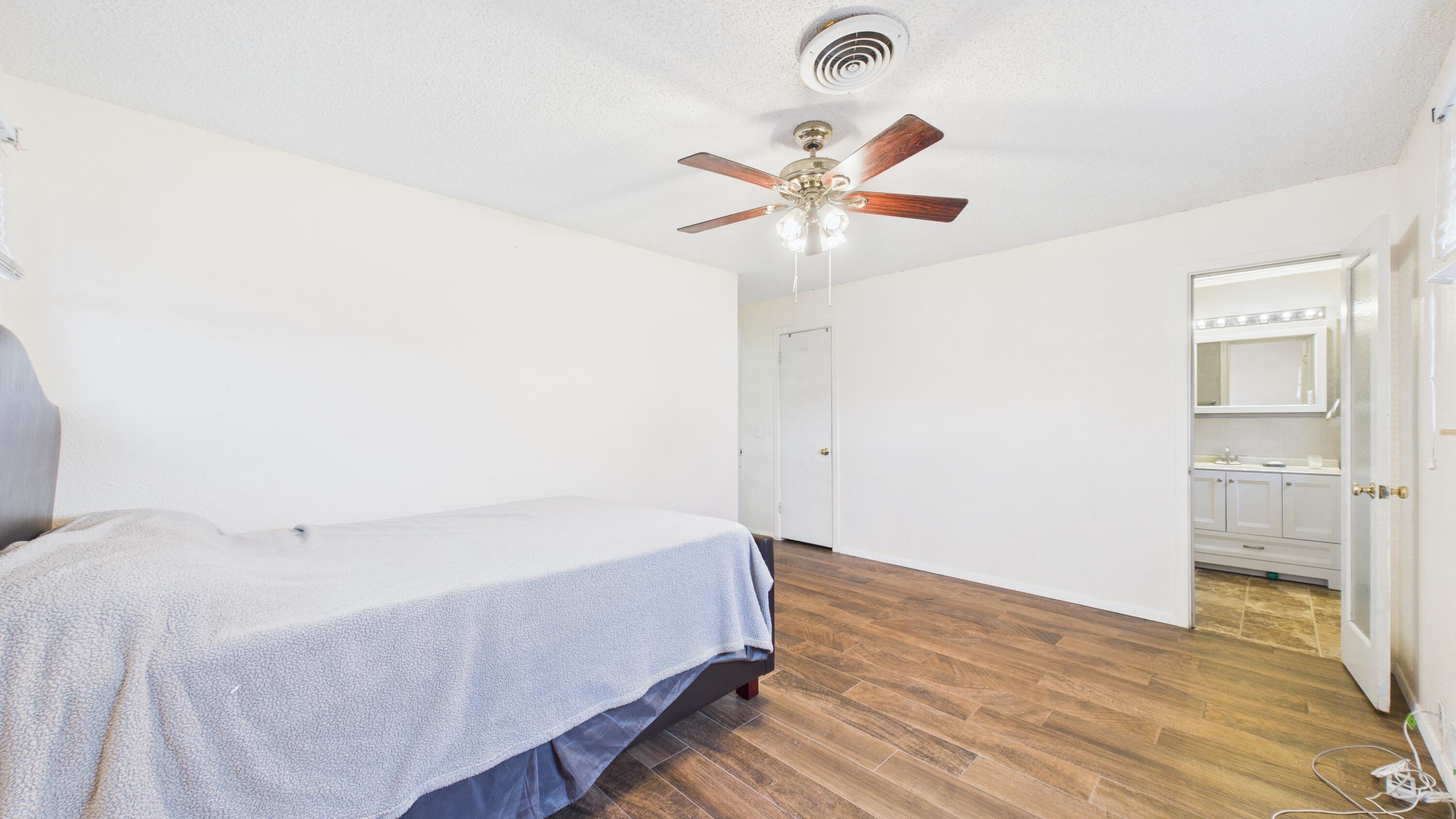 5410 41st Street Lubbock, TX 79414 - Photo 29 of 40 a bedroom with a bed and a chandelier