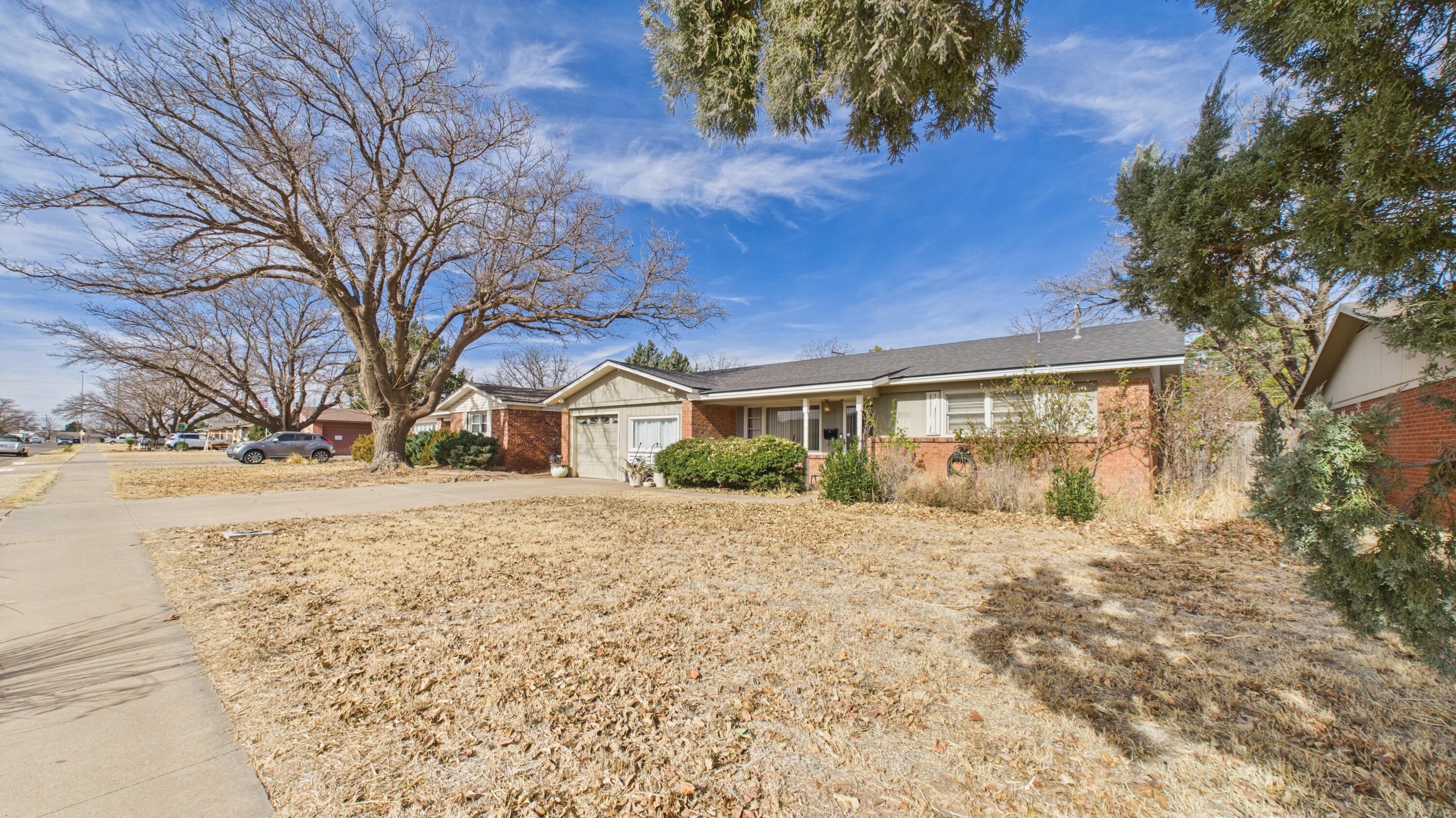 5410 41st Street Lubbock, TX 79414 - Photo 3 of 40 a front view of a house with a yard covered with snow