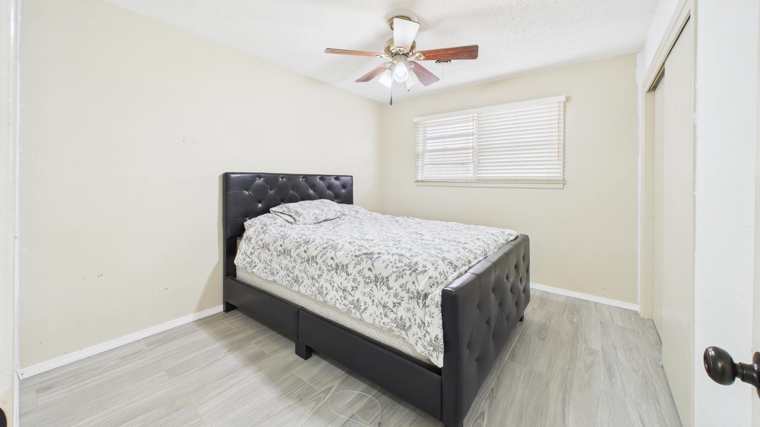 5410 41st Street Lubbock, TX 79414 - Photo 32 of 40 a bedroom with a bed and a chandelier