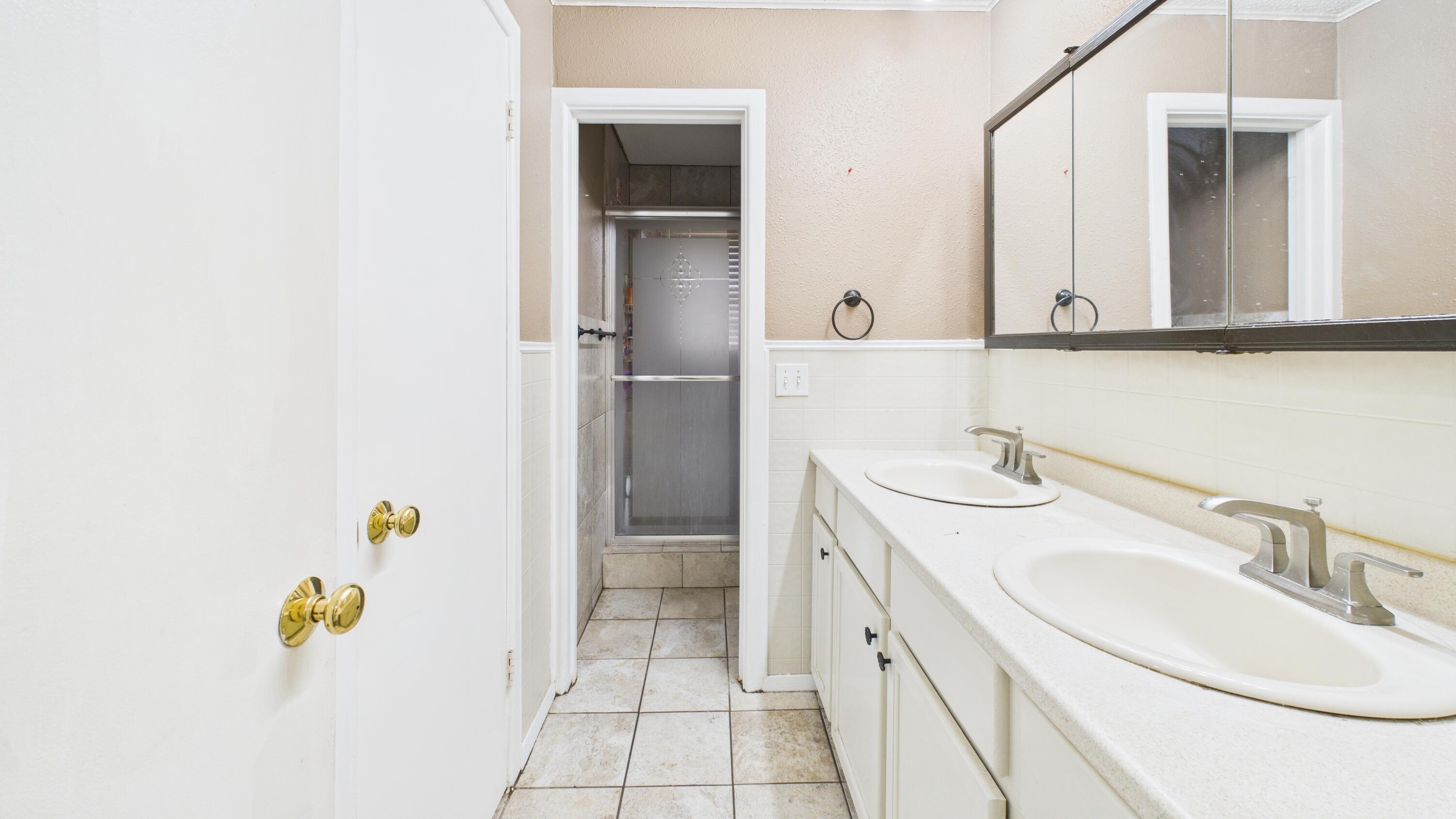 5410 41st Street Lubbock, TX 79414 - Photo 35 of 40 a bathroom with a sink and a mirror