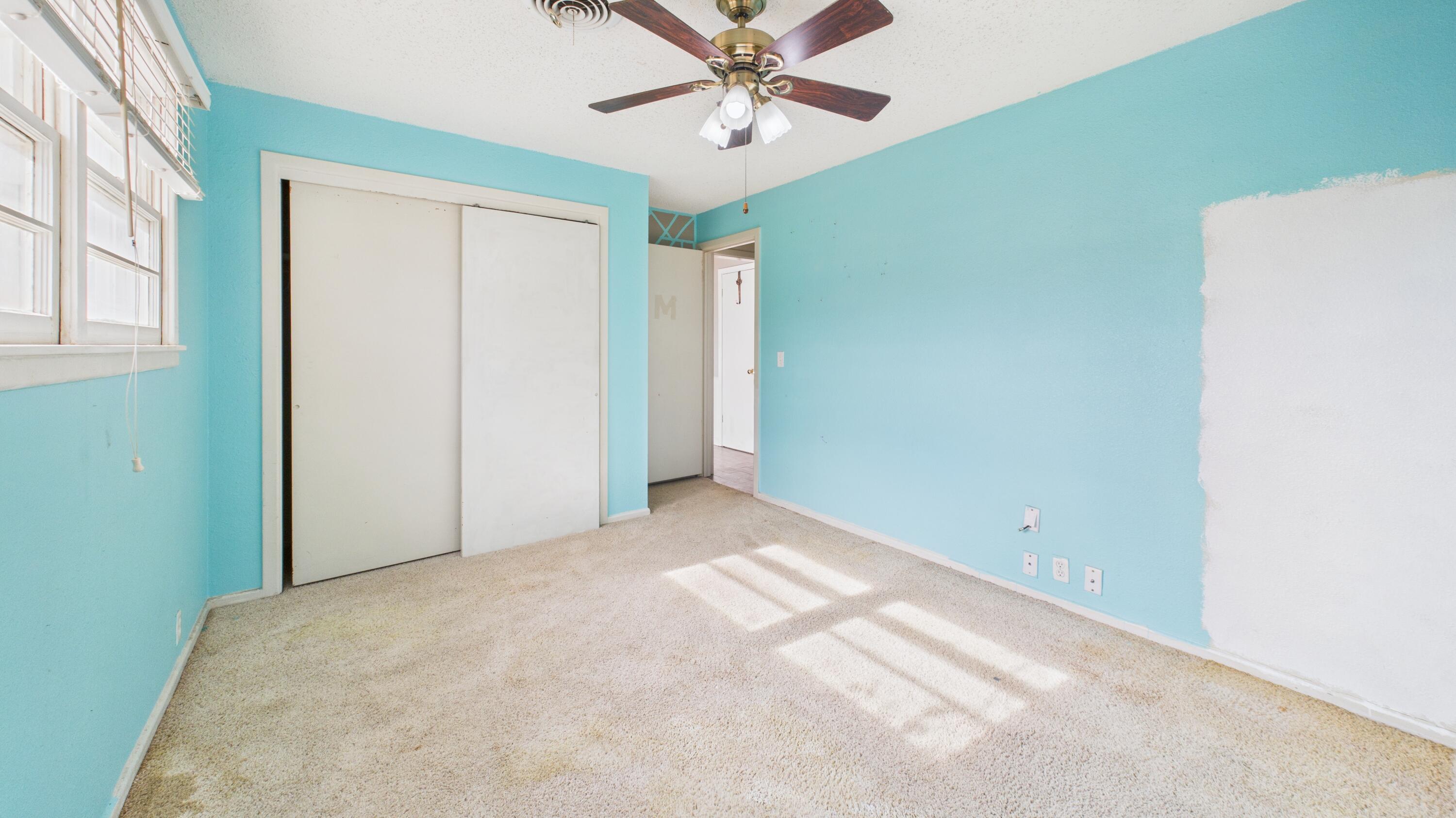 5410 41st Street Lubbock, TX 79414 - Photo 39 of 40 a view of a bedroom with a ceiling fan and a window