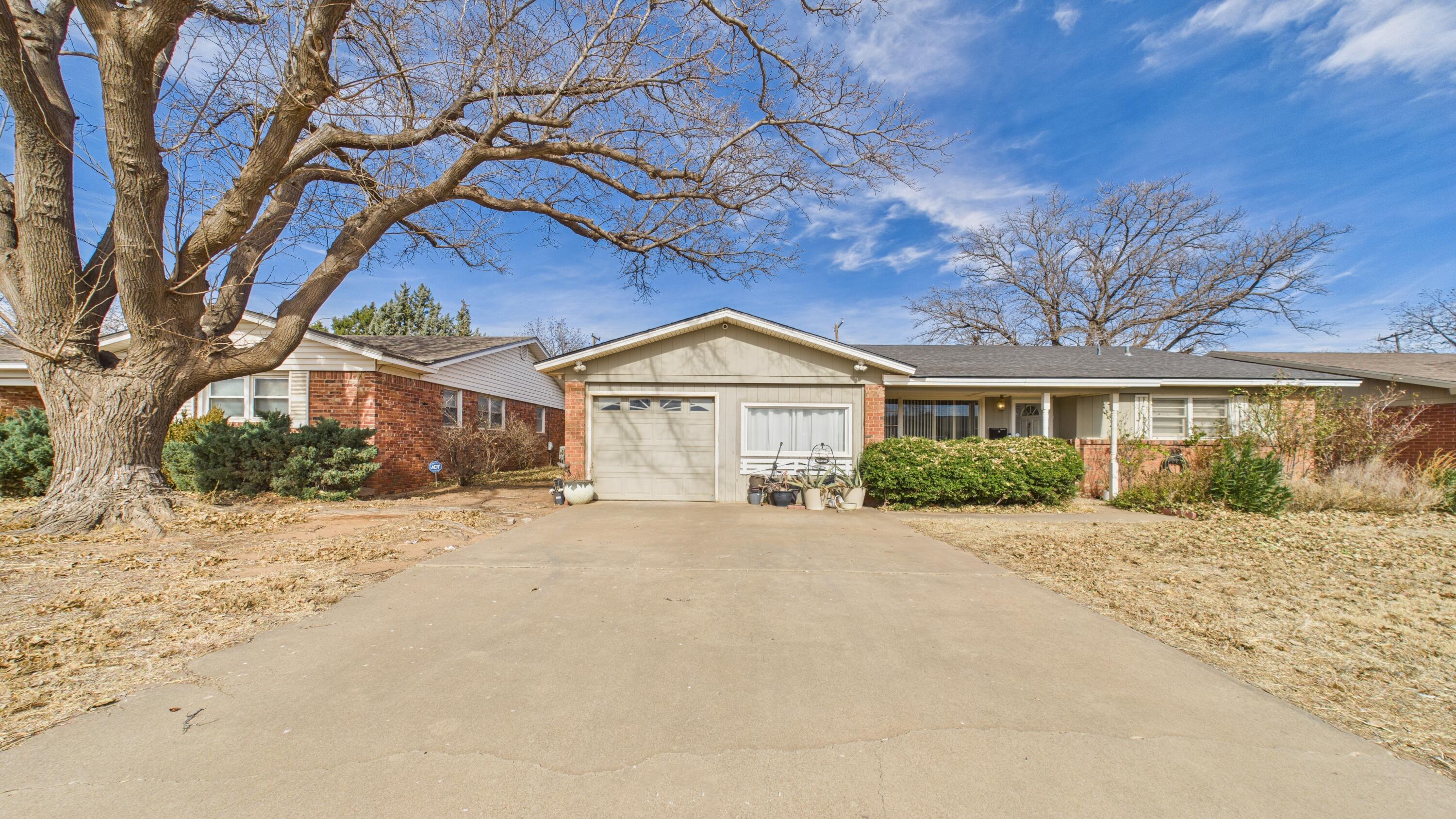 5410 41st Street Lubbock, TX 79414 - Photo 4 of 40 a front view of a house with a yard