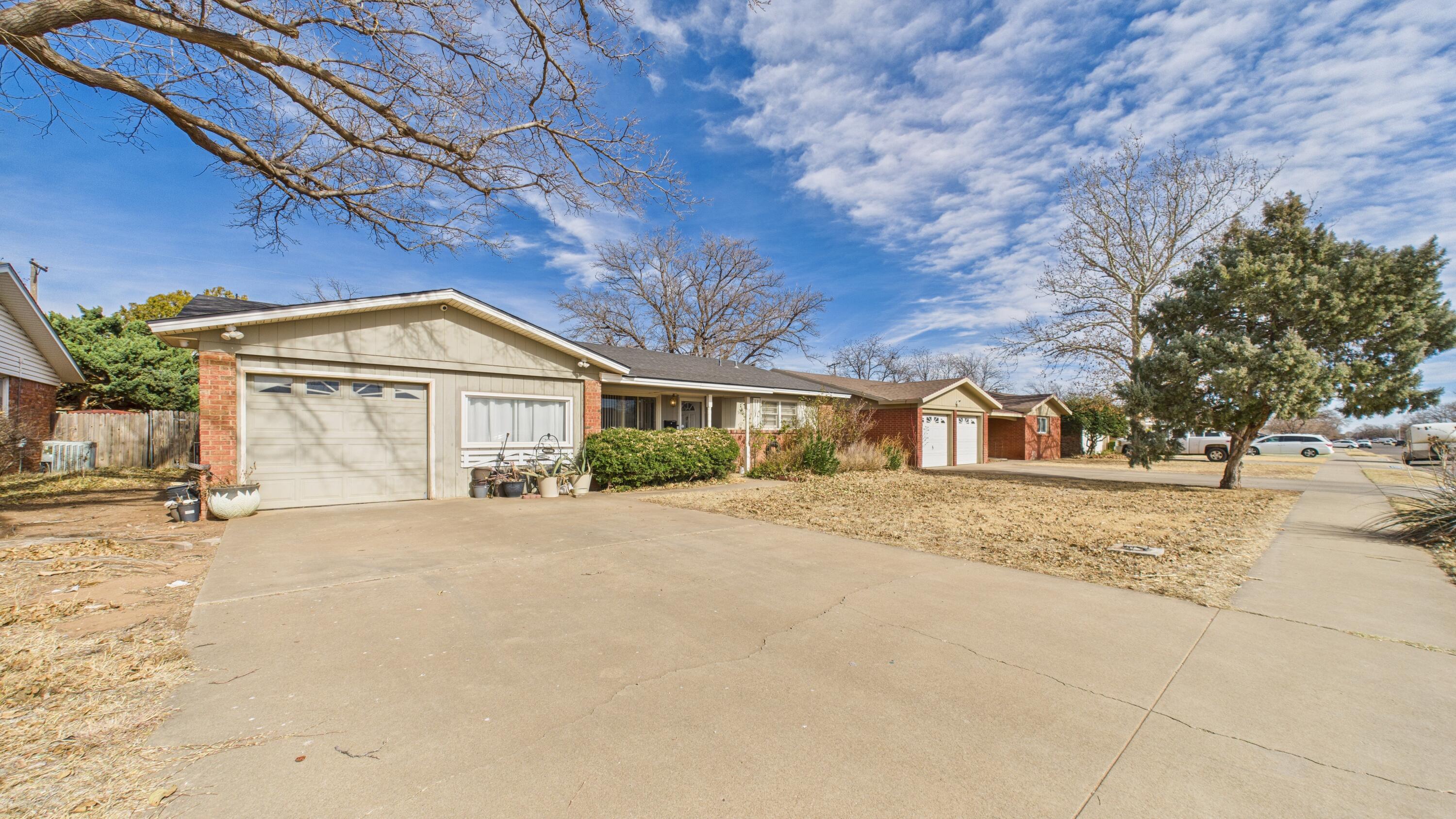 5410 41st Street Lubbock, TX 79414 - Photo 5 of 40 a front view of a house with a yard