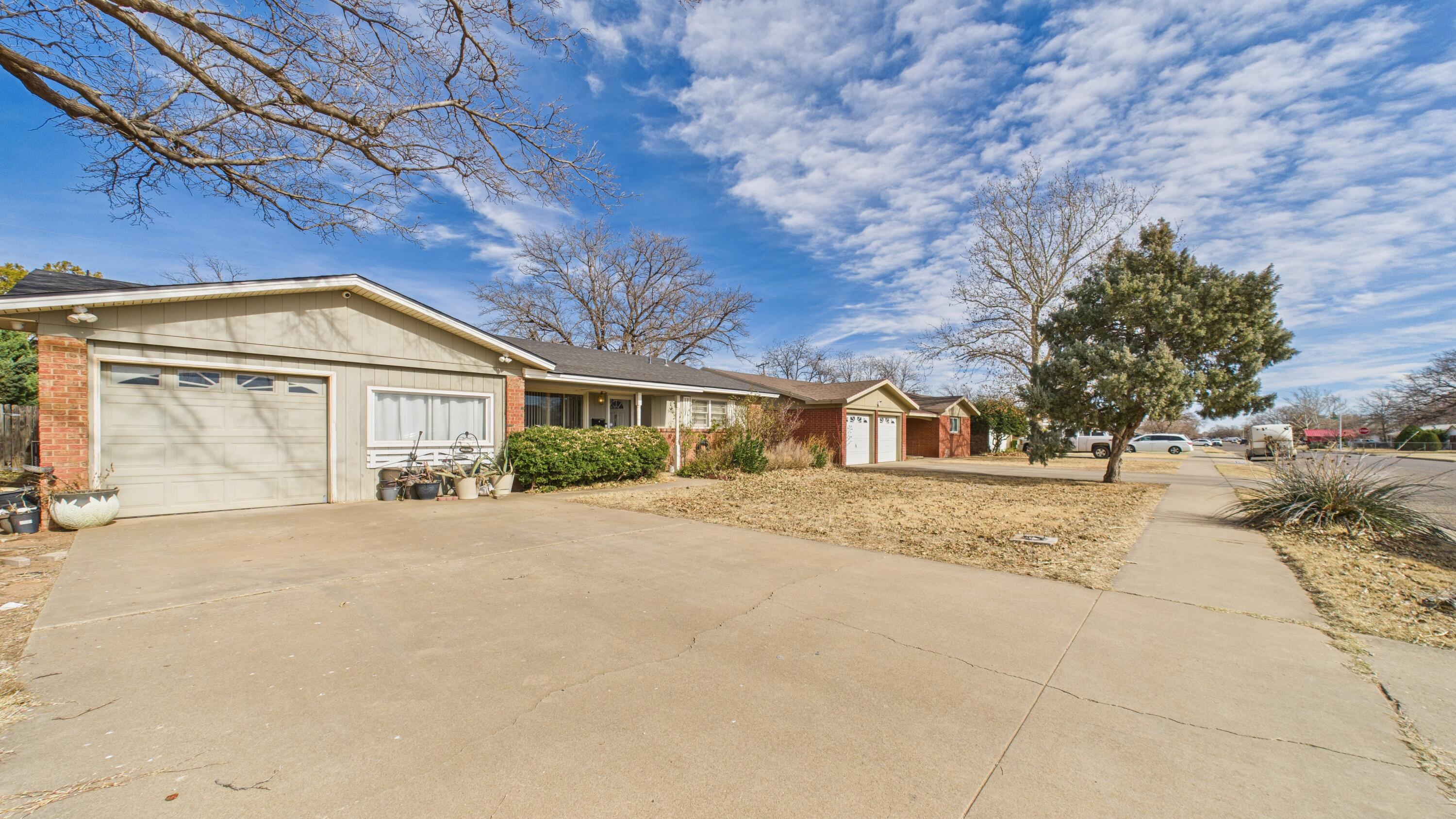 5410 41st Street Lubbock, TX 79414 - Photo 6 of 40 a front view of a house with a yard and garage