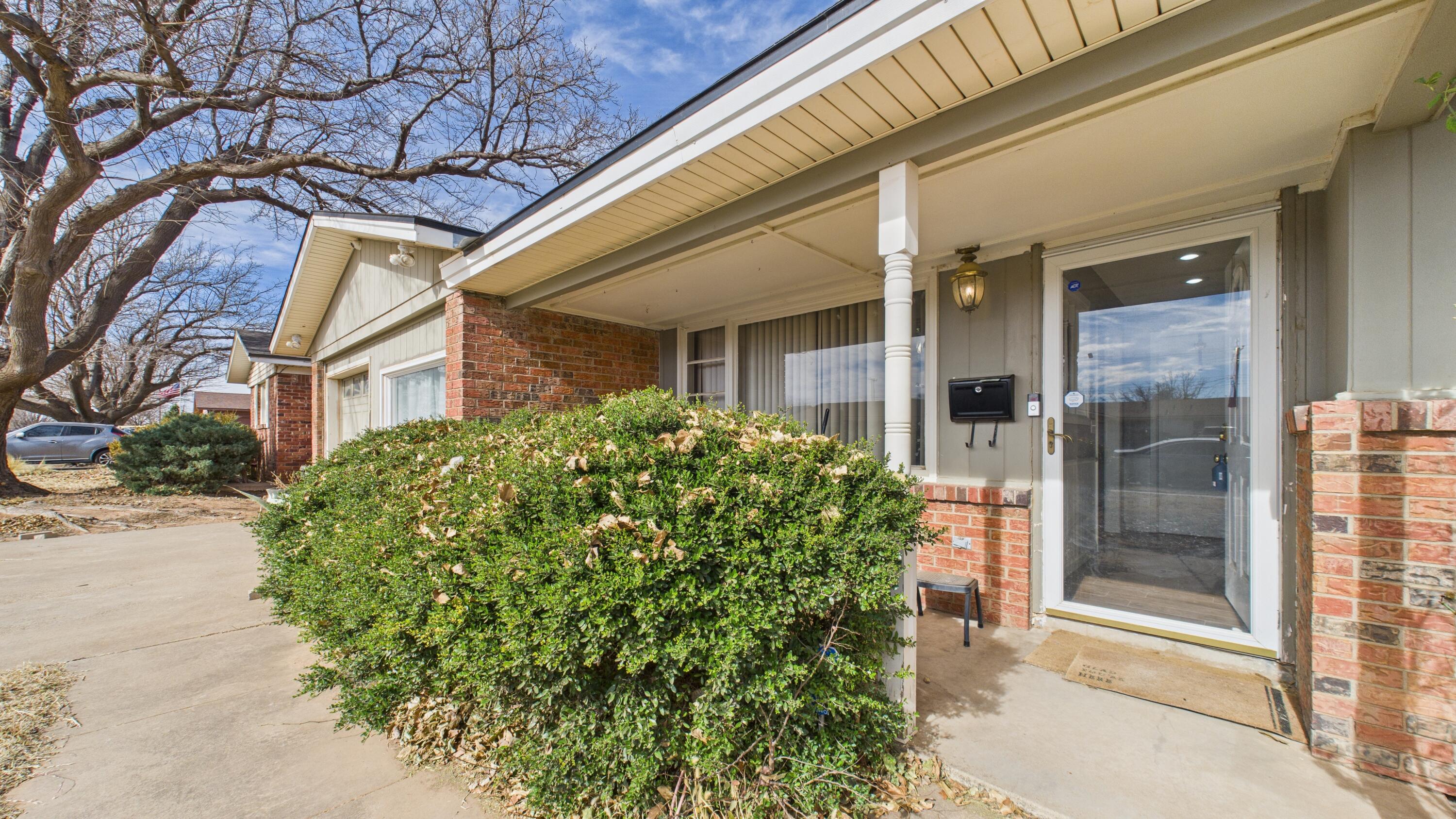 5410 41st Street Lubbock, TX 79414 - Photo 7 of 40 a couple of potted plants in front of a building