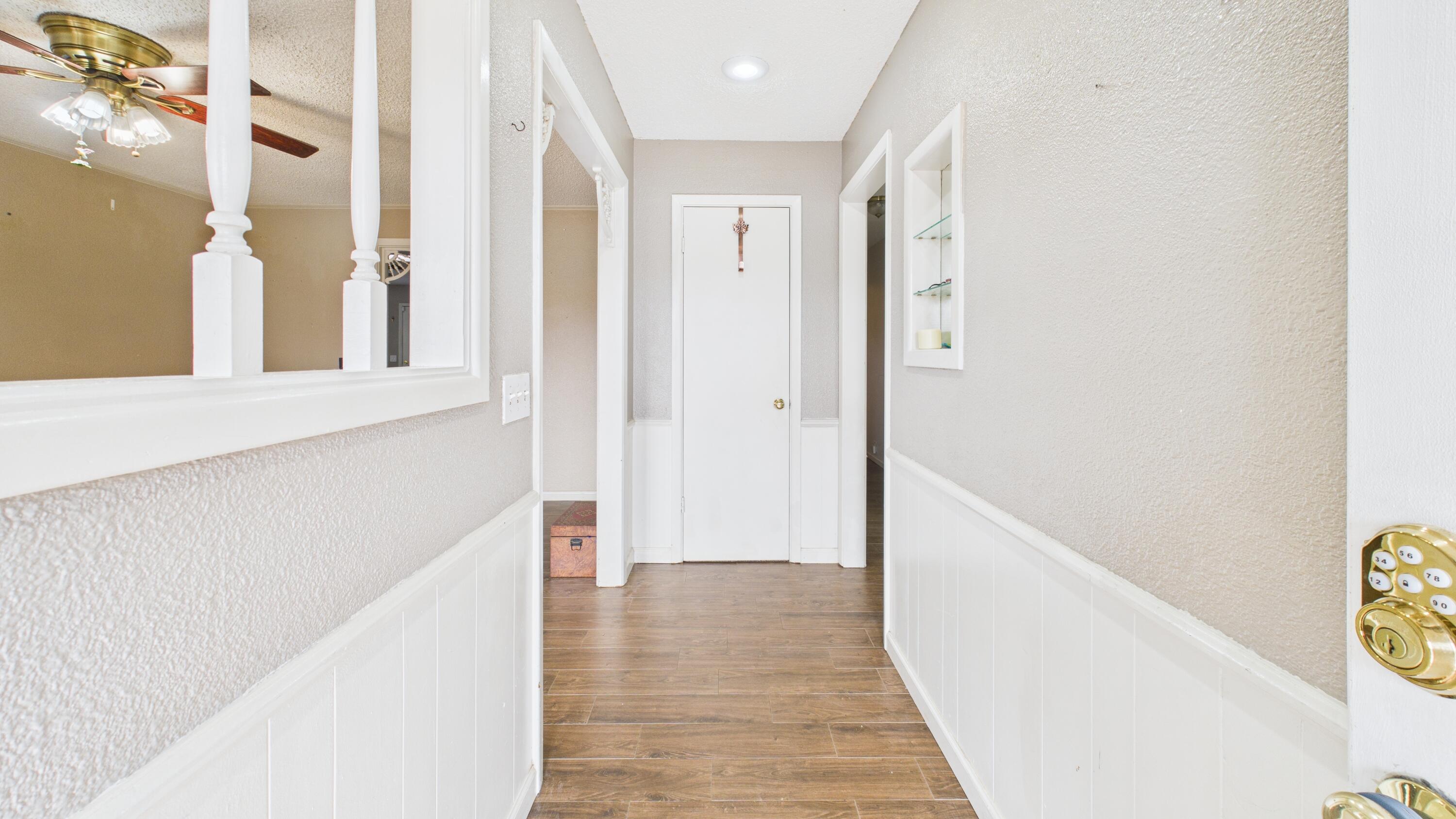5410 41st Street Lubbock, TX 79414 - Photo 9 of 40 a view of a hallway with wooden floor and staircase