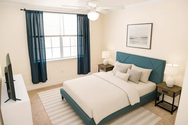 a bedroom with a bed and a large window