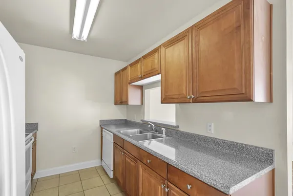 a kitchen with a sink cabinets and a window