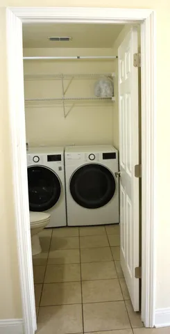 a bathroom with a granite countertop sink toilet and mirror