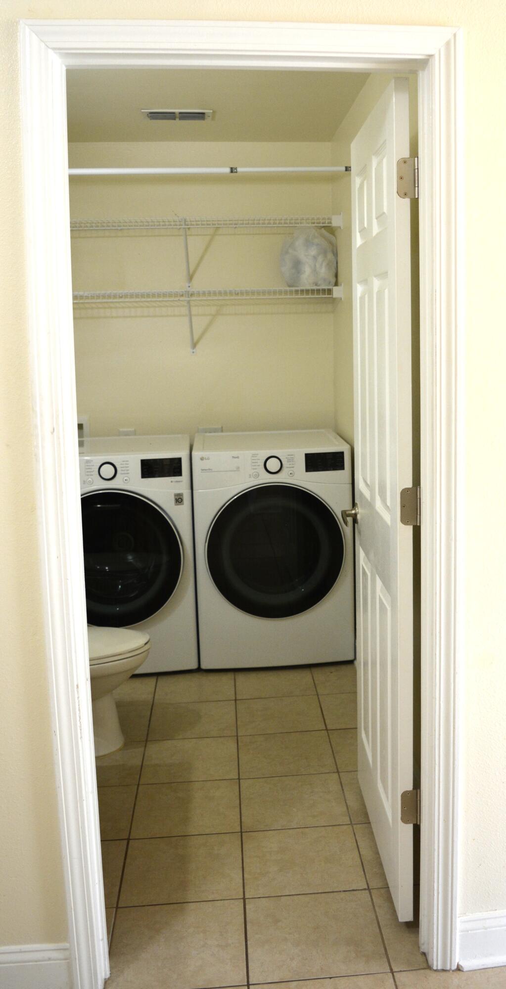 506 Wingspan Way Crestview, FL 32536 - Photo 16 of 38 a bathroom with a sink and a washing machine