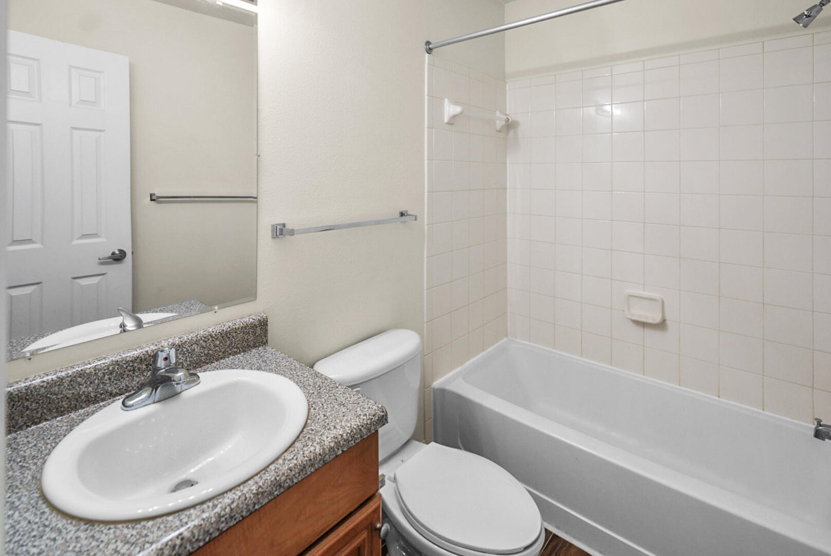 506 Wingspan Way Crestview, FL 32536 - Photo 17 of 33 a bathroom with a granite countertop sink mirror toilet and bathtub