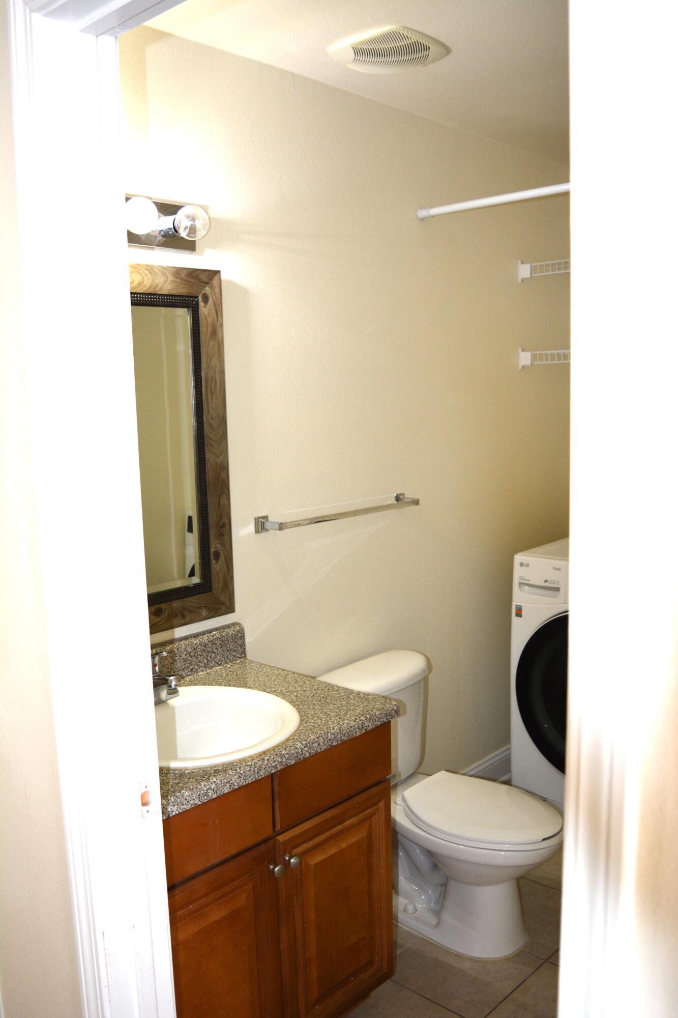 506 Wingspan Way Crestview, FL 32536 - Photo 17 of 38 a bathroom with a granite countertop sink toilet and mirror