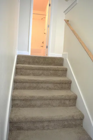 a view of a hallway with wooden shelves