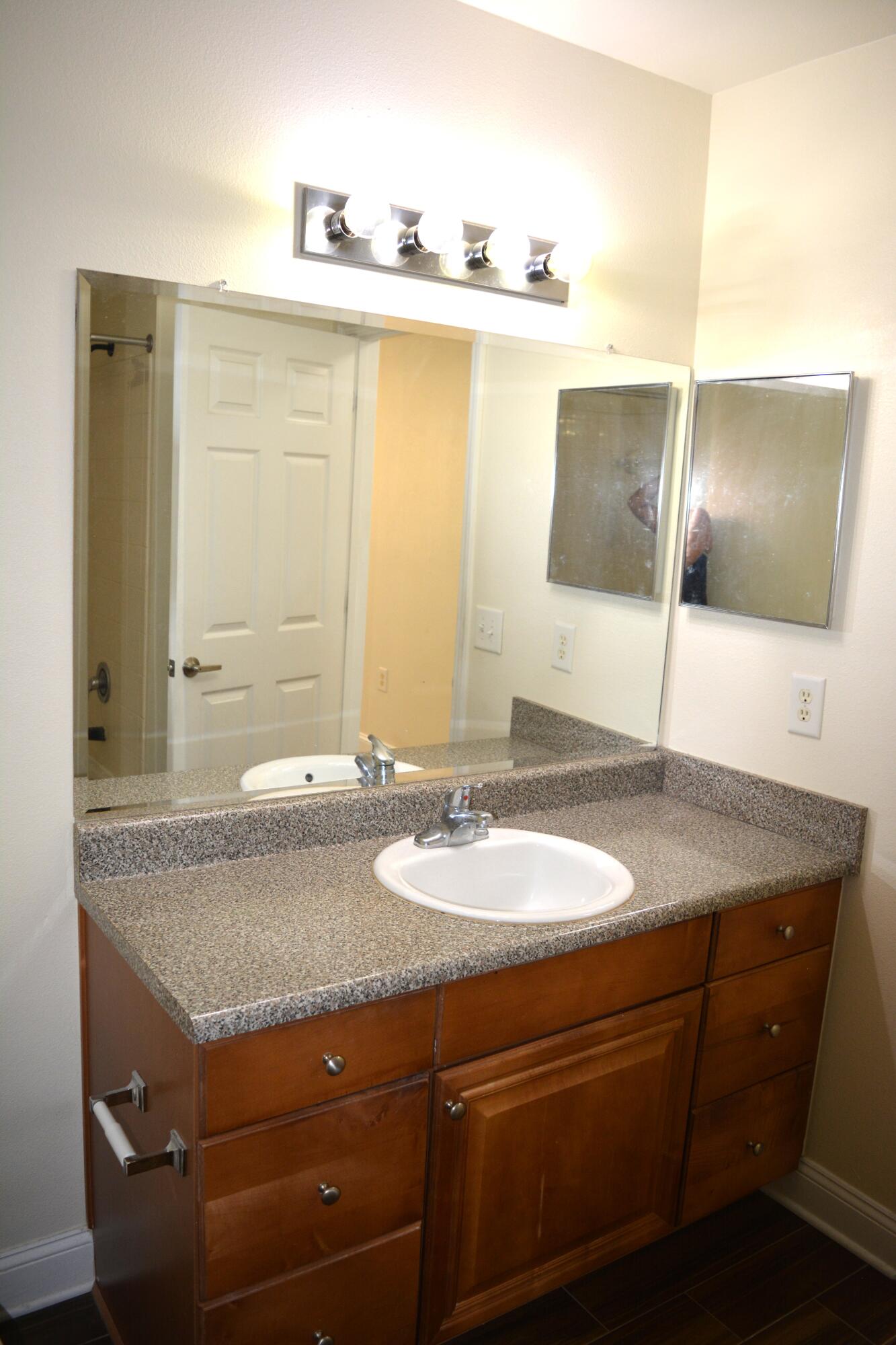 506 Wingspan Way Crestview, FL 32536 - Photo 32 of 38 a bathroom with a granite countertop sink and a mirror