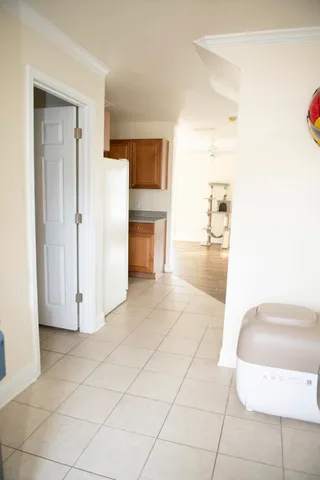 a view of kitchen with furniture and refrigerator
