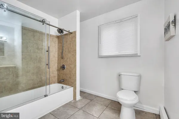 a bathroom with a toilet a sink and bathtub