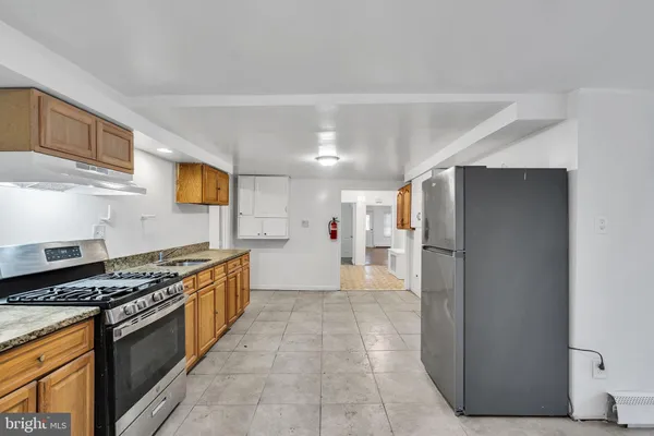 a kitchen with stainless steel appliances a refrigerator and a stove