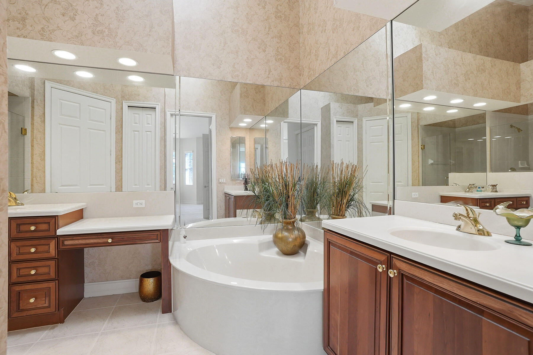 8605 Champions Point, Unit 103 Naples, FL 34113 - Photo 26 of 44 a bathroom with a sink a large mirror and a shower