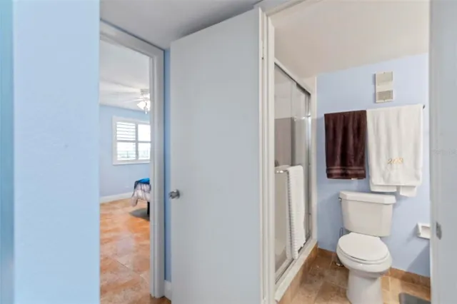 a bathroom with a toilet sink and shower
