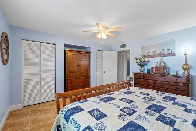 a bedroom with a bed and a dresser in it