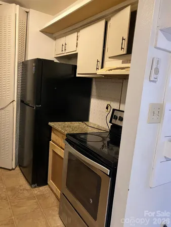 a kitchen with a refrigerator and a stove
