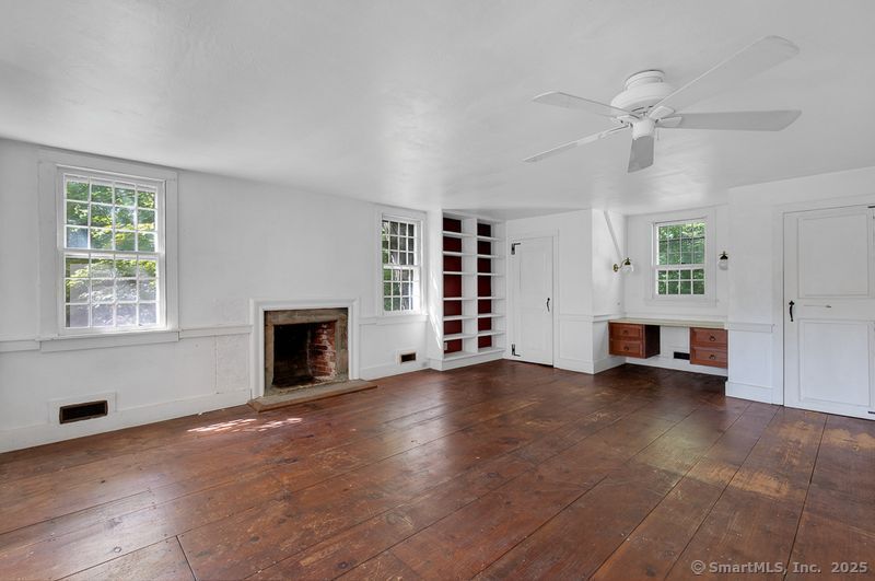 208 Woodcreek Road Bethlehem, CT 06751 - Photo 13 of 29 an empty room with windows and fireplace