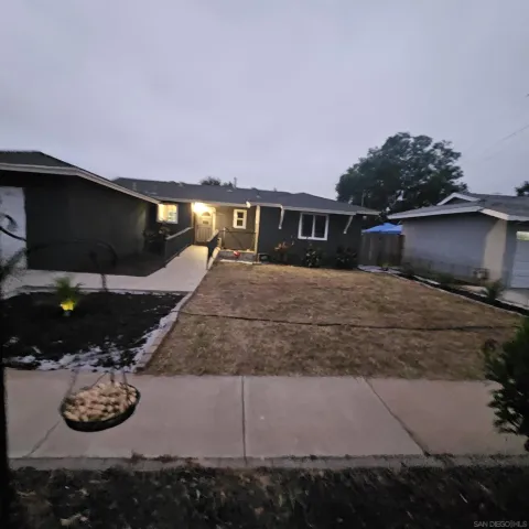 a view of a house with backyard and sitting area