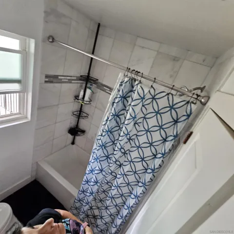 a bathroom with a bathtub and shower