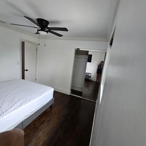 a bedroom with a bed and a mirror