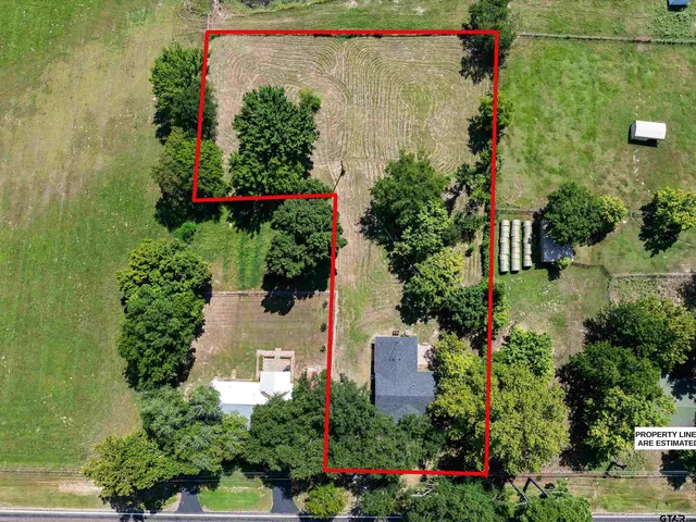 a aerial view of a house with a yard