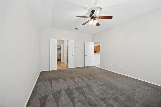 a view of a livingroom with a ceiling fan and window