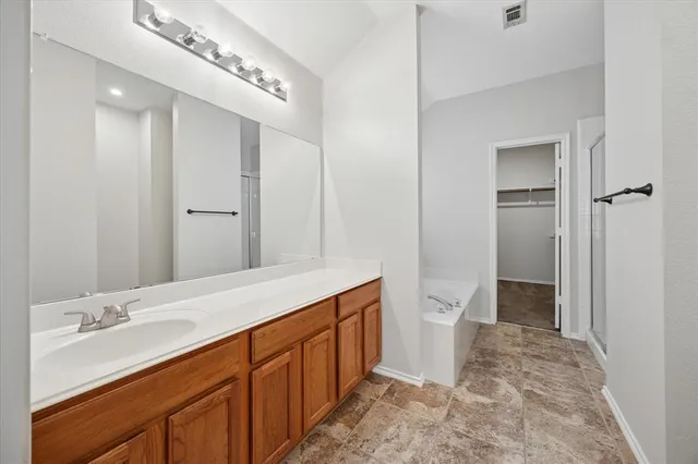 a spacious bathroom with a double vanity sink and a mirror