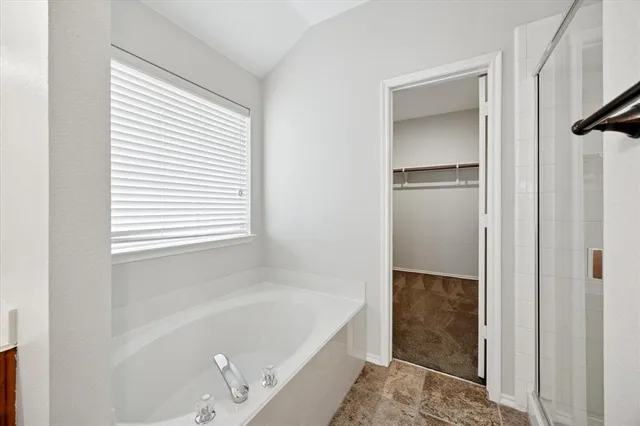 a bathroom with a bathtub and a shower