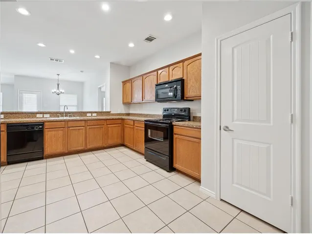 a large kitchen with cabinets and stainless steel appliances