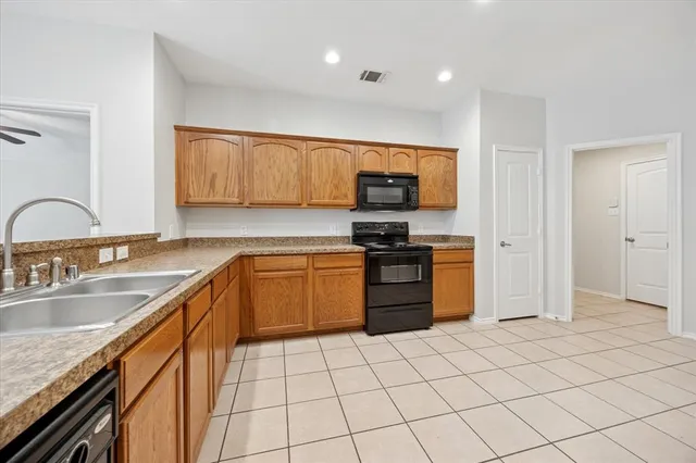 a kitchen with stainless steel appliances granite countertop a sink stove and cabinets