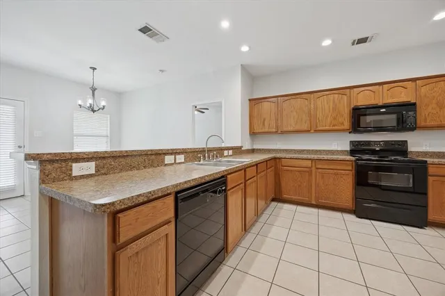 a kitchen with a sink a stove and cabinets
