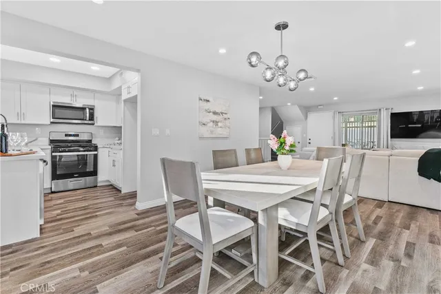 a view of a dining room with furniture and wooden floor