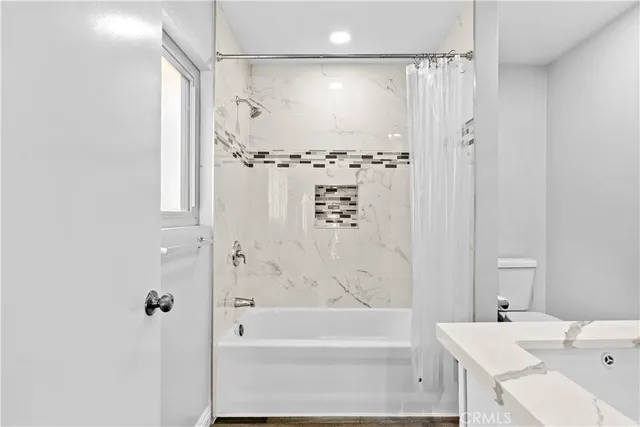 a bathroom with a bathtub and a shower