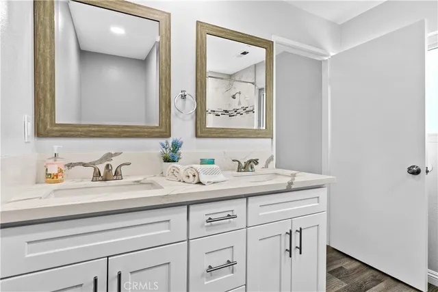 a bathroom with a granite countertop sink and a mirror