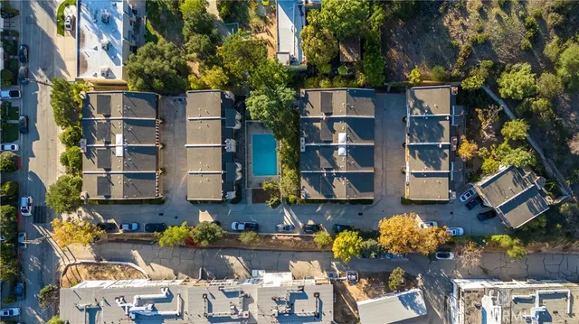 a front view of a house with a yard and fountain in middle